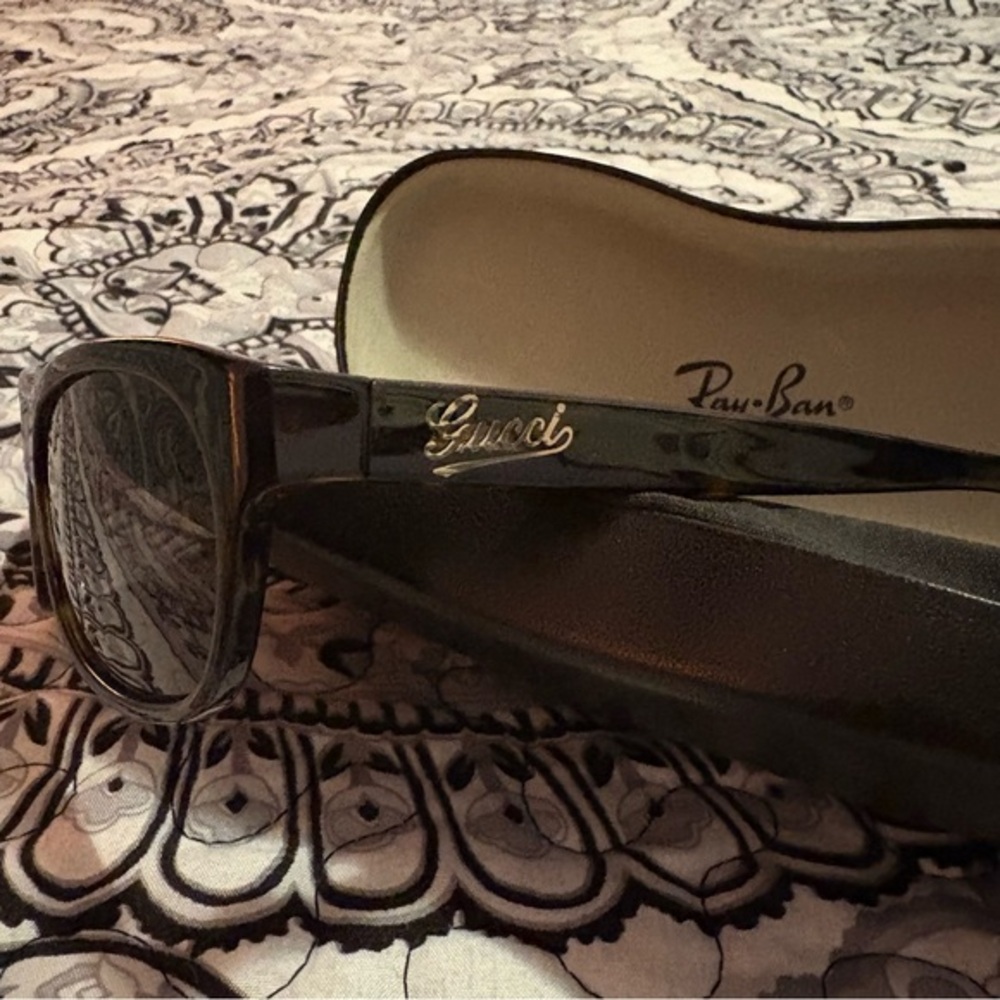 Gucci Sunglasses in a Ray-bands case.